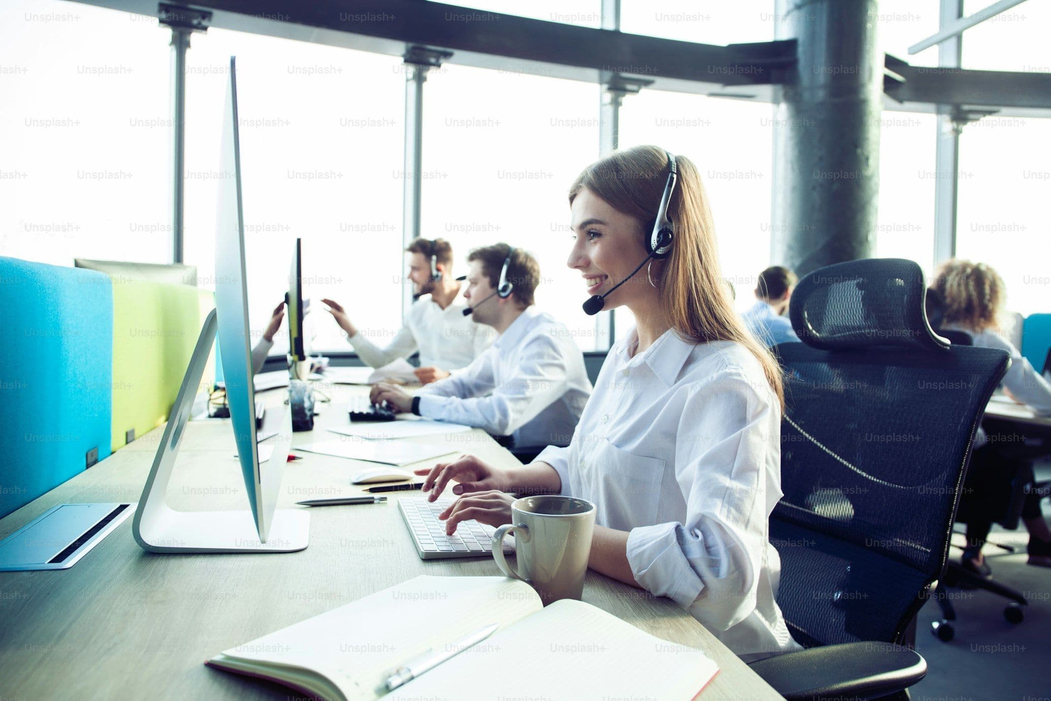 Customer support agent with headset providing remote assistance